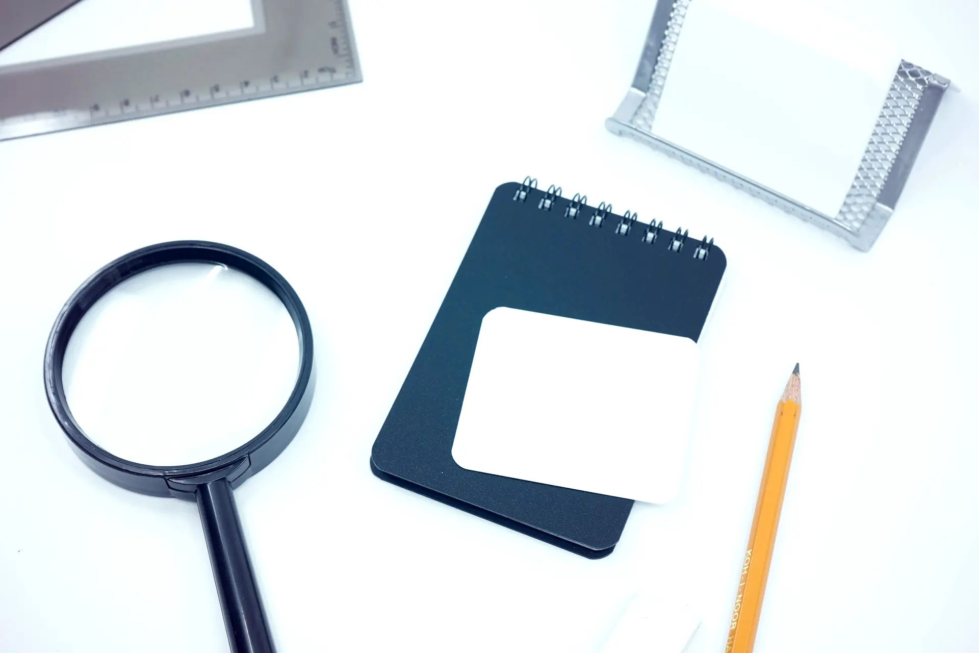 black magnifying glass on white paper